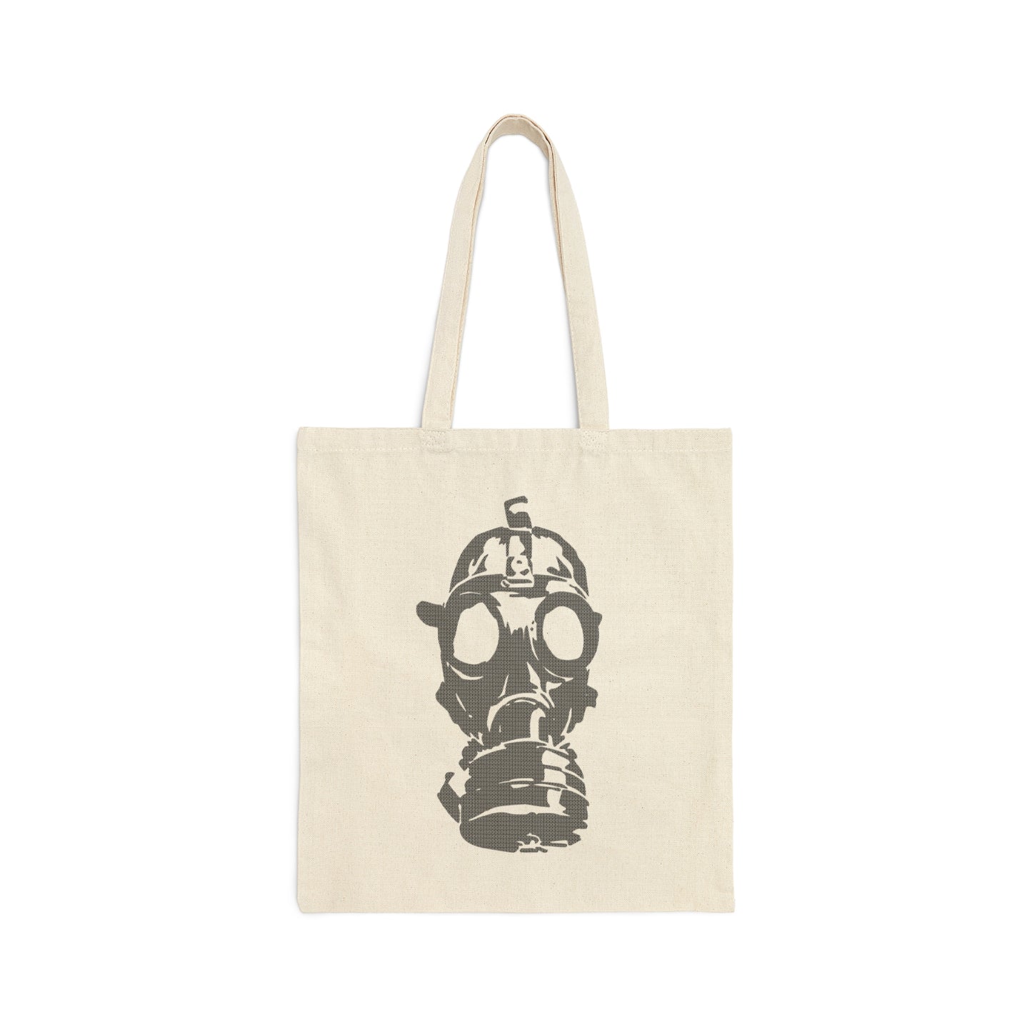 Tan canvas tote bag with large image of gray gas mask in center and handles above, against a white background.