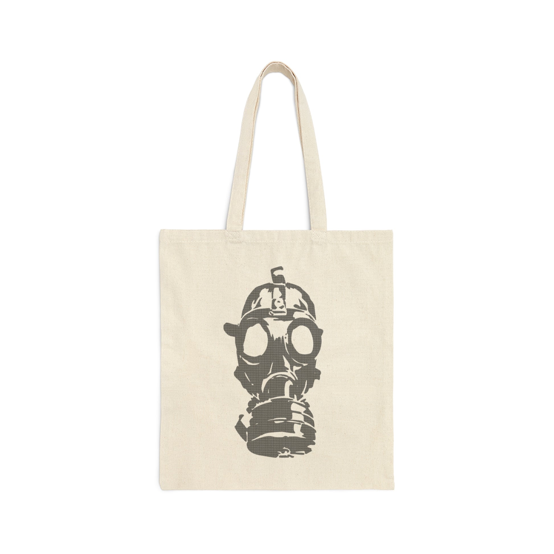 Tan canvas tote bag with large image of gray gas mask in center and handles above, against a white background.