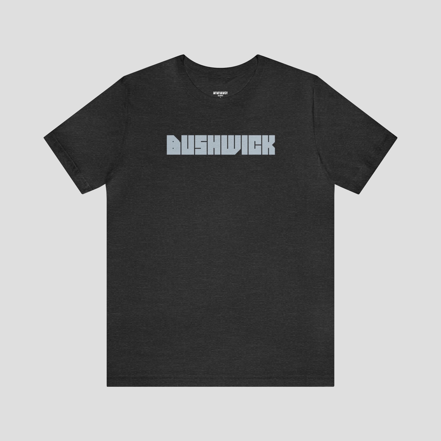 Dark gray t-shirt with "Bushwick"with "Bushwick" in white block letters (in center) against a white background.