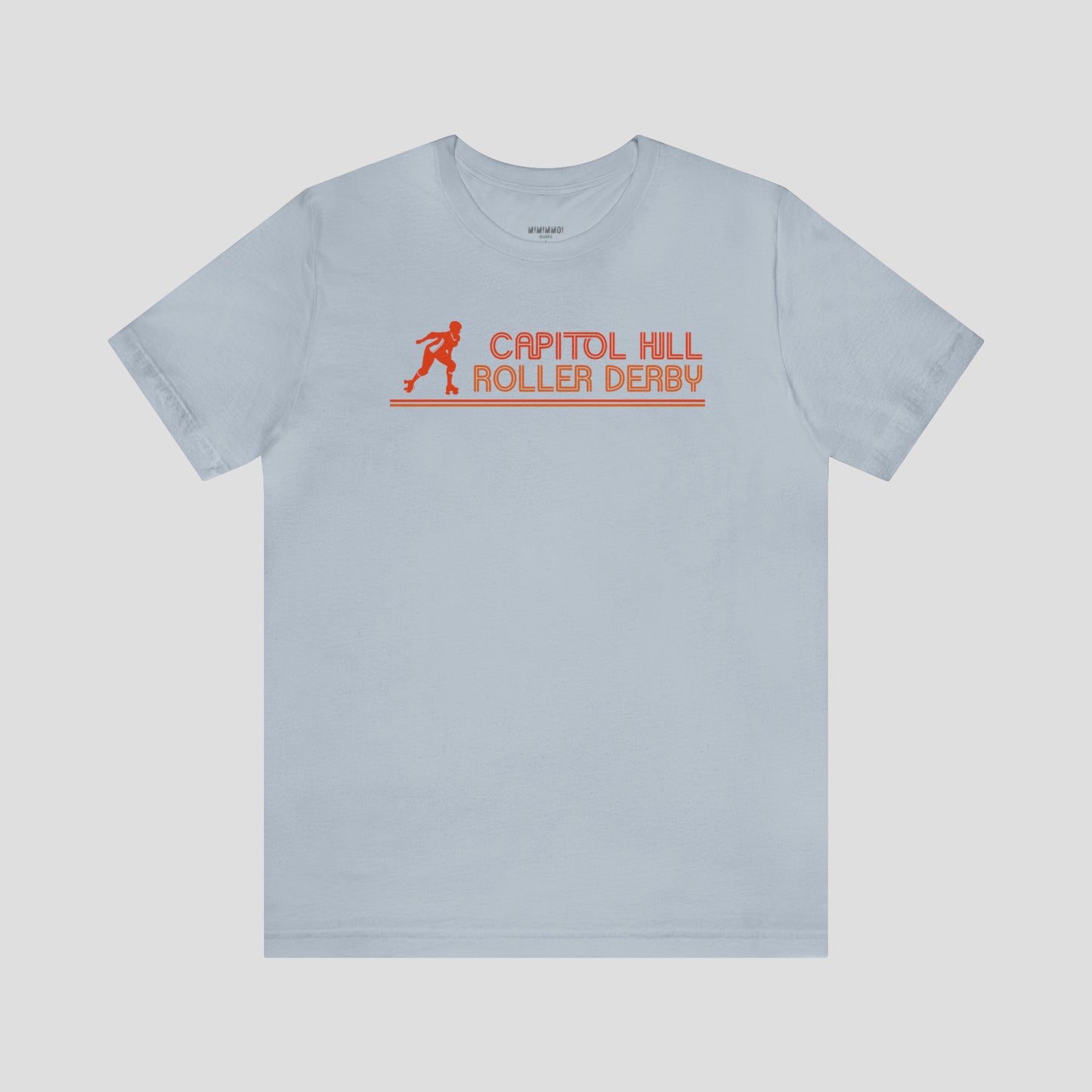 Light blue t-shirt with the words "Capitol Hill Roller Derby" written in orange, lined font and silhouette image of a roller derby player to the left of the words across the chest, against a gray background.