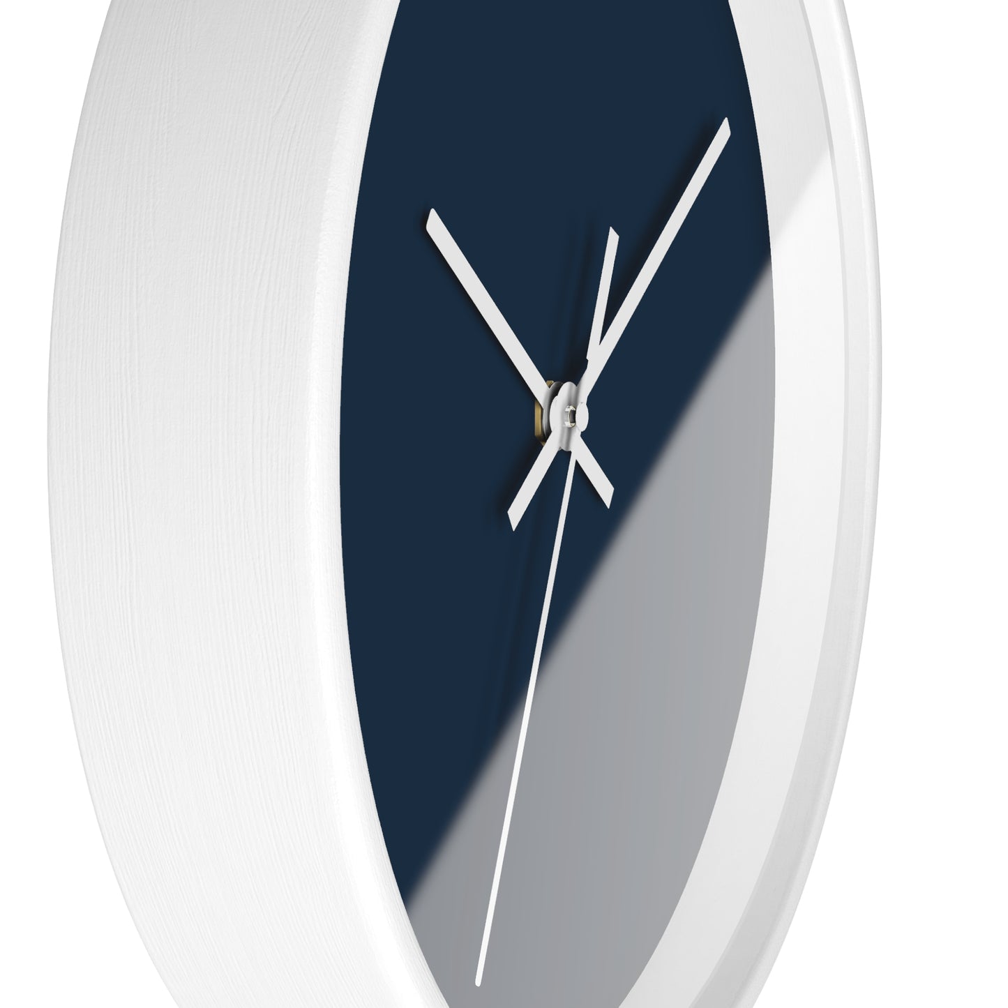 Side view of white circular wooden framed clock with navy blue background and white hands against a white background.