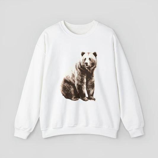 White sweatshirt with large bear sitting and looking to the side against light gray background.