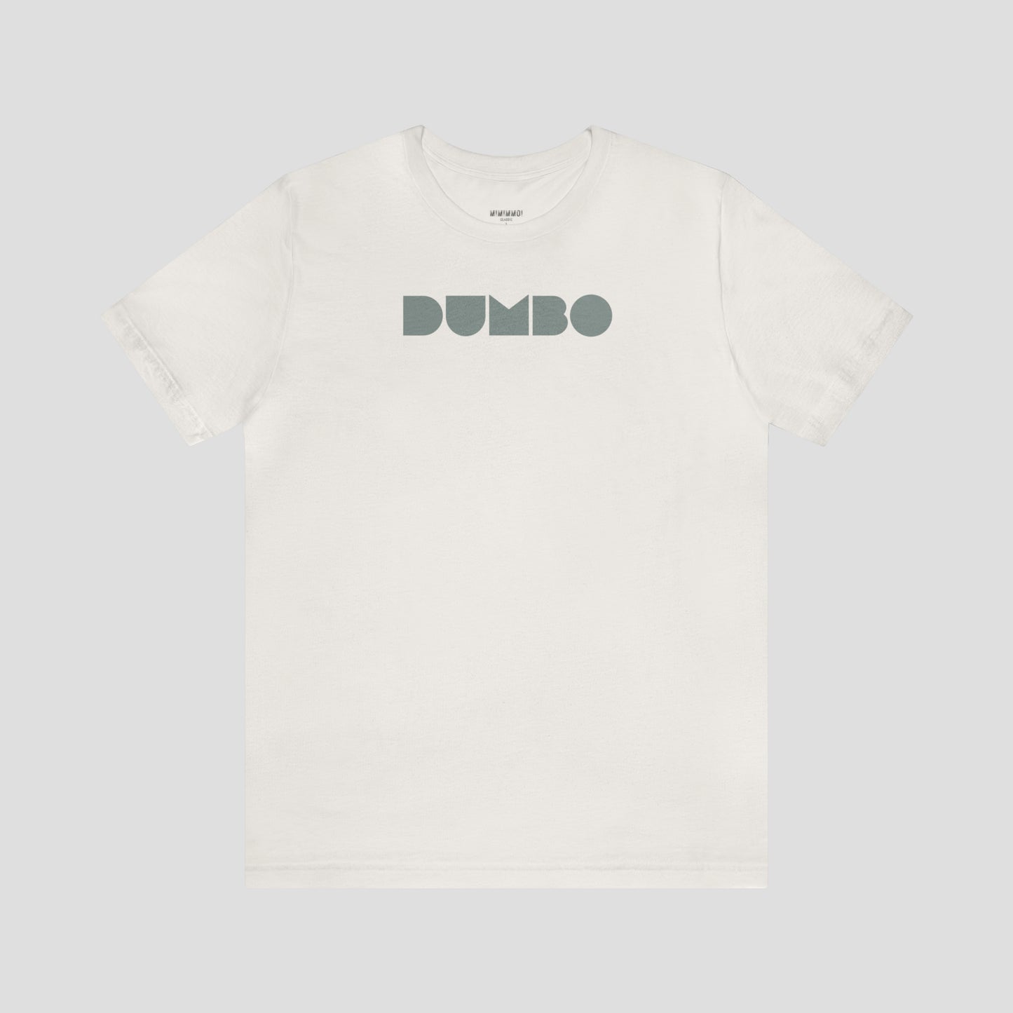 Vintage white t-shirt with the word Dumbo in gray block letters across the chest, against a gray background.