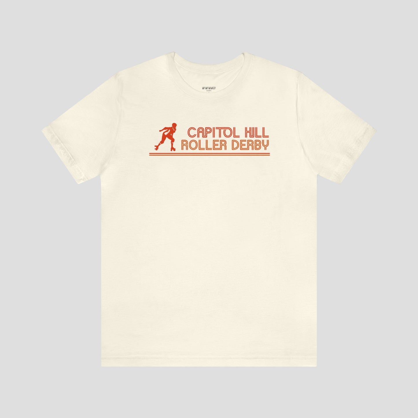 Natural beige colored t-shirt with the words "Capitol Hill Roller Derby" written in orange, lined font and silhouette image of a roller derby player to the left of the words across the chest, against a gray background.