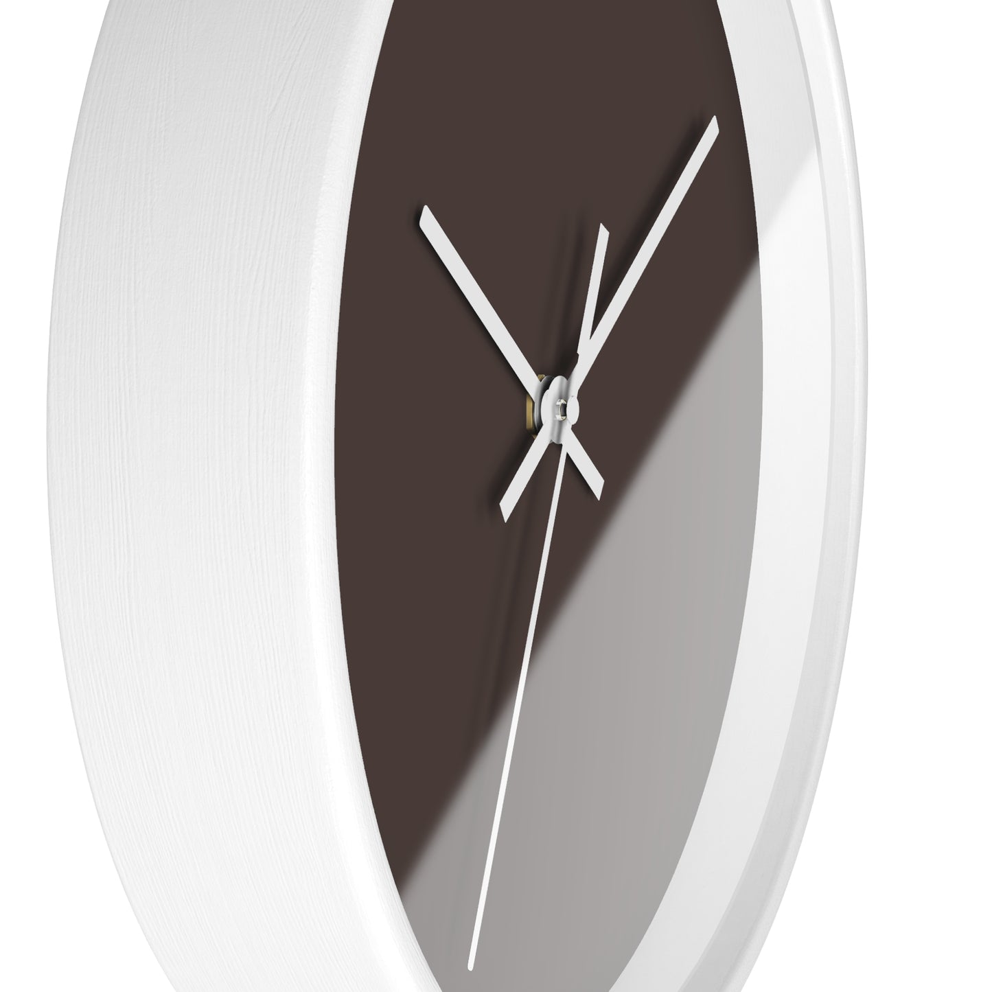 Side view of white circular wooden framed clock with espresso brown background and white hands, against a white  background.