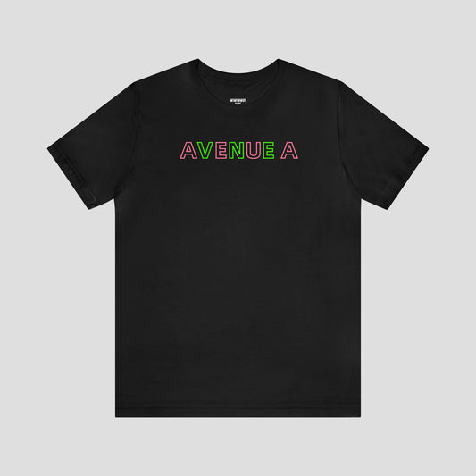 Black T-shirt with the words Avenue A in alternating pink and green block letters against light gray background.