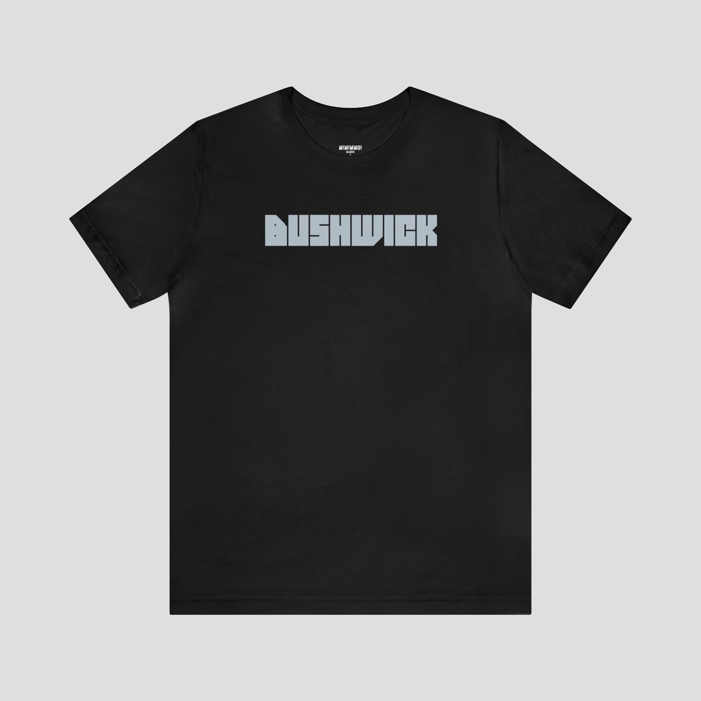 Black t-shirt with "Bushwick"with "Bushwick" in white block letters (in center) in center against a white background.