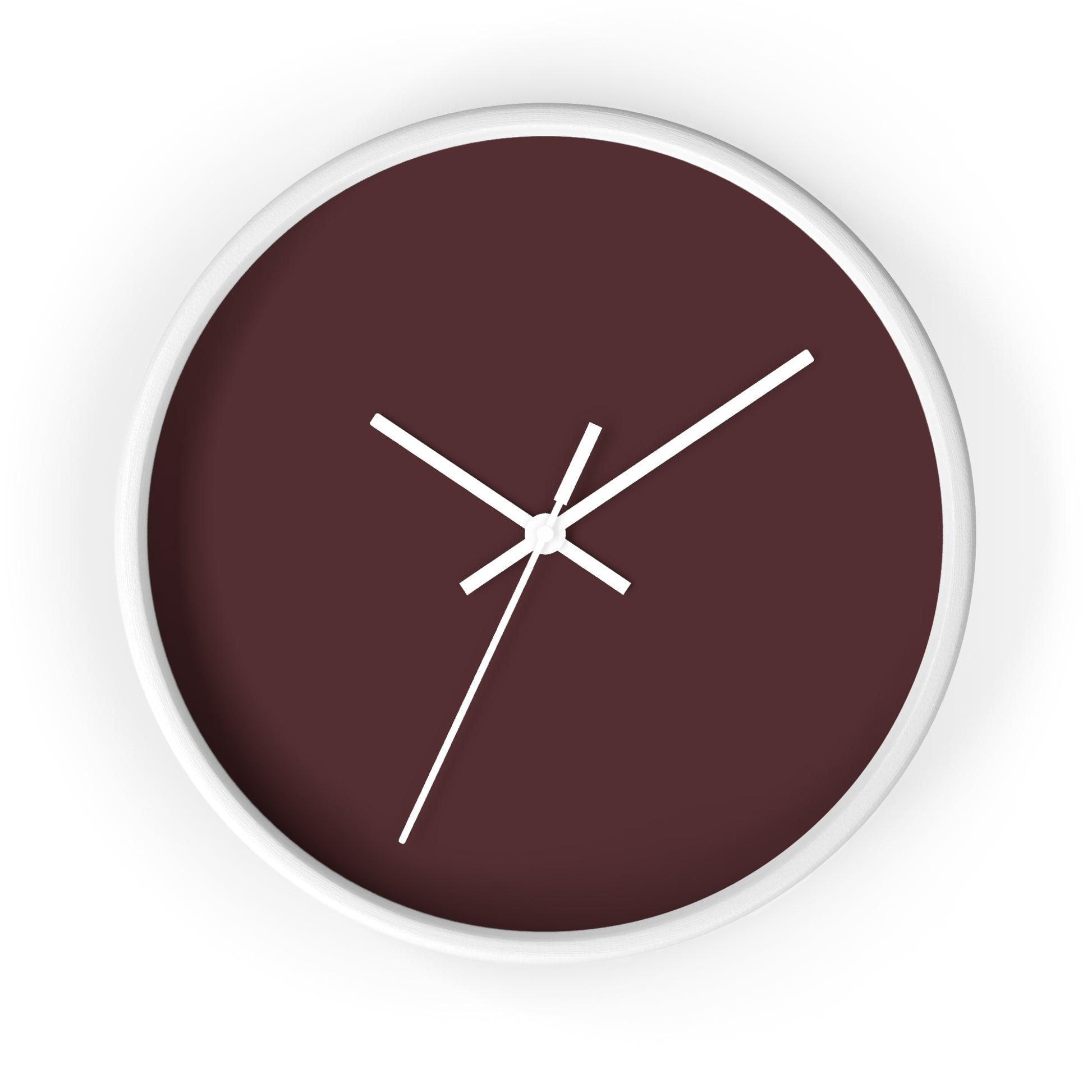 White circular wooden framed clock with maroon colored background and white hands against a white background.