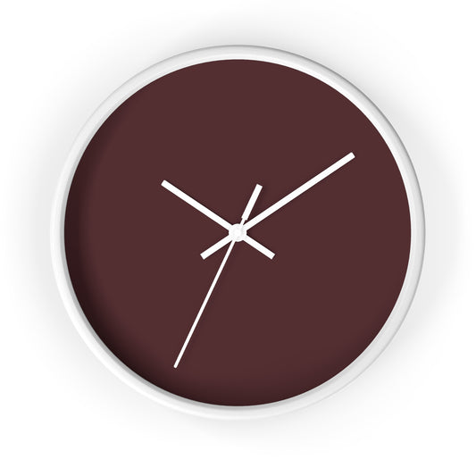 White circular wooden framed clock with maroon colored background and white hands against a white background.