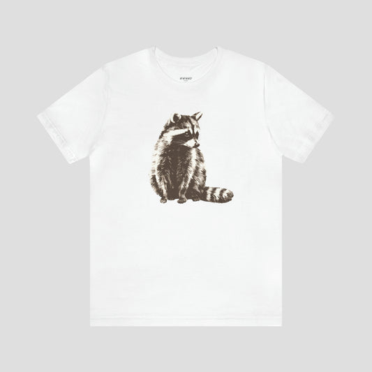 White t-shirt with large brown and white illustrated image of a racoon across the chest, against a gray background.