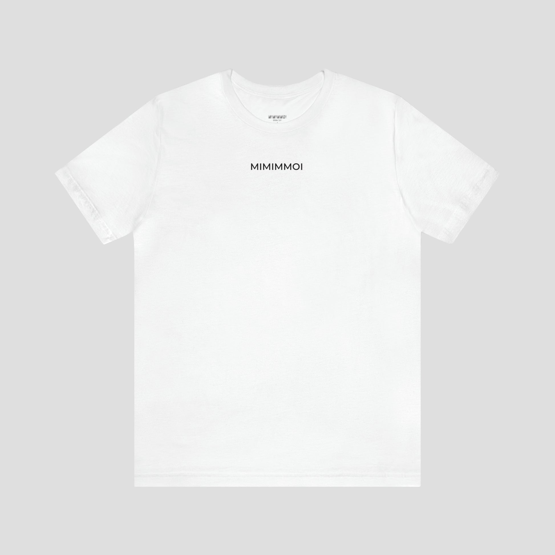 White t-shirt with the word "Mimimmoi" in small black letters a few inches under the neckline, against a gray background.