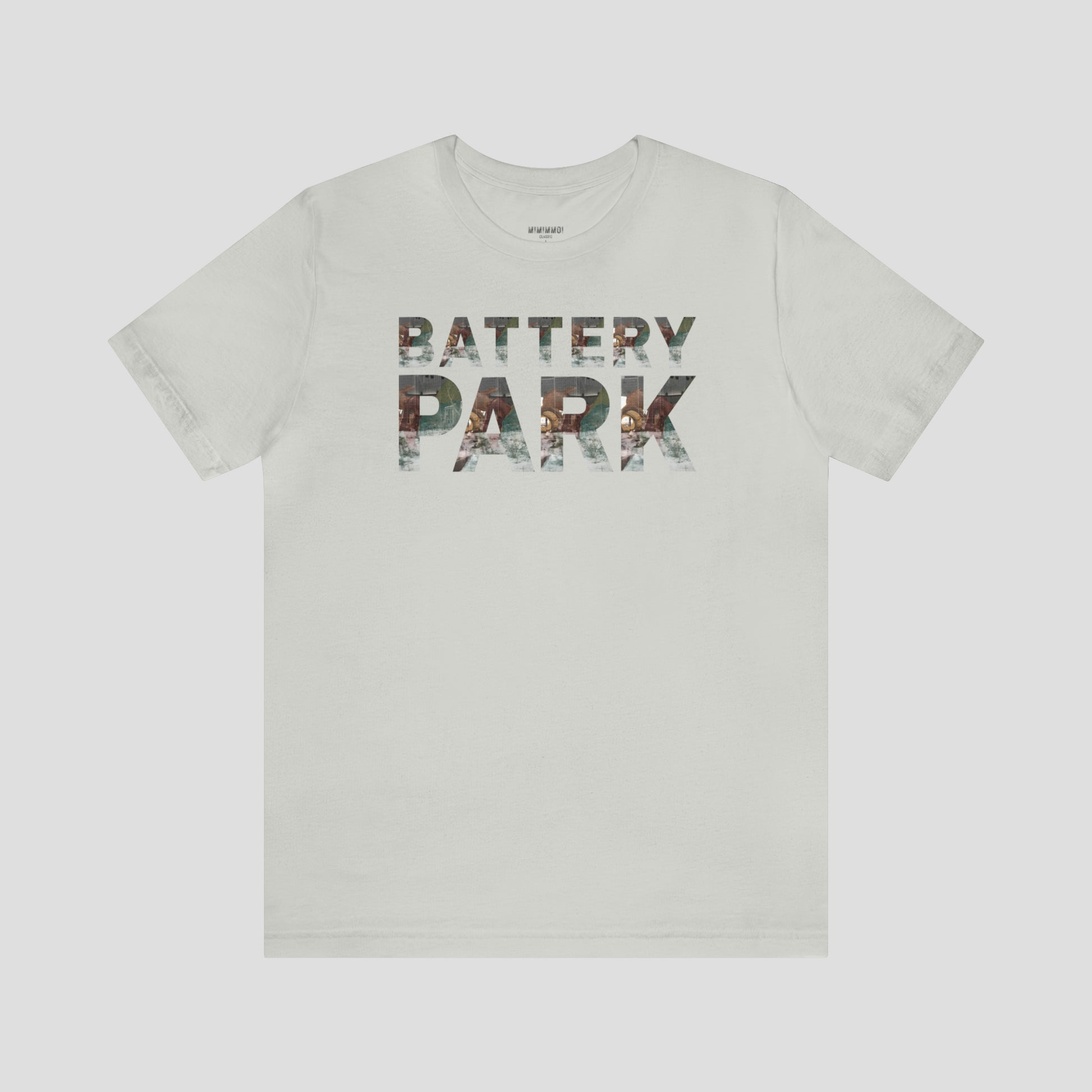 Light silver t-shirt with Battery Park in block letters. A picture of the SeaGlass Carousel is in each block letter against light gray background.